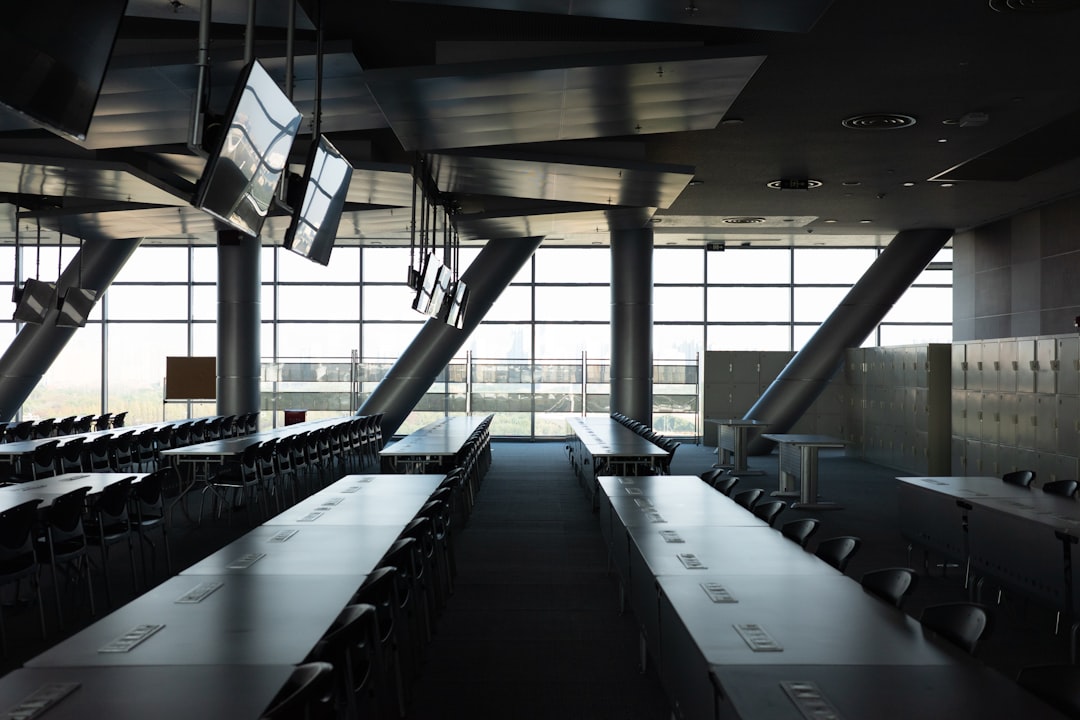 Modern conference room with long tables and large windows