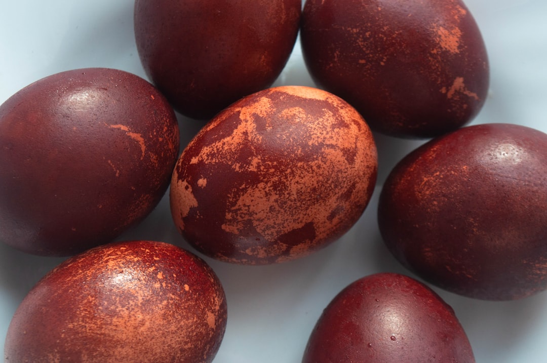Dyed brown eggs arranged on a white surface.