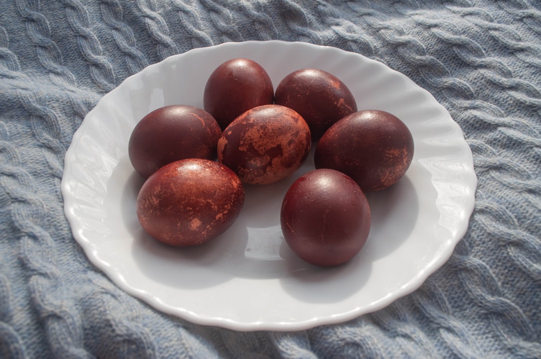 Dyed eggs are presented on a white plate.