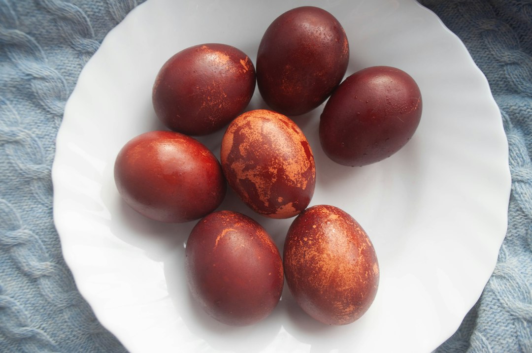 Several brown dyed easter eggs on a white plate
