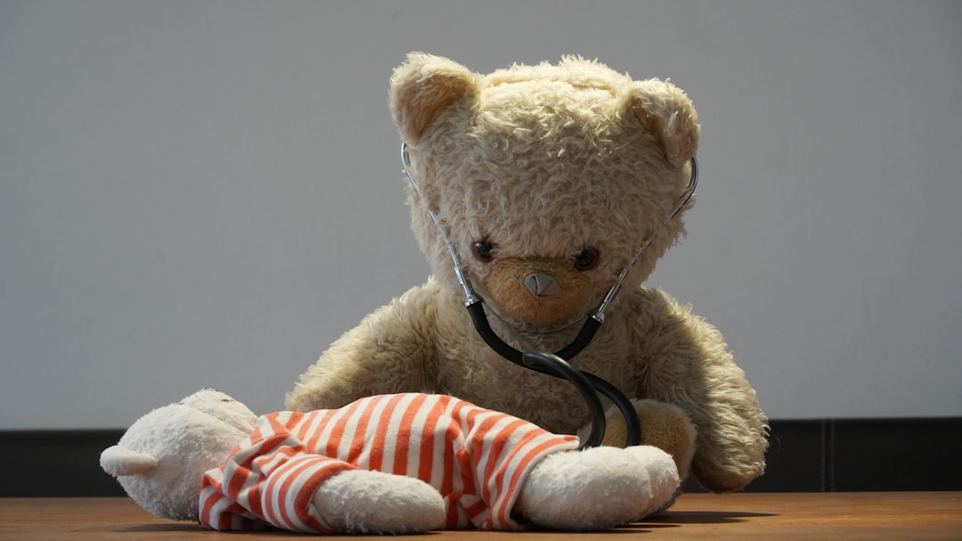 Teddy bear with stethoscope checks another bear
