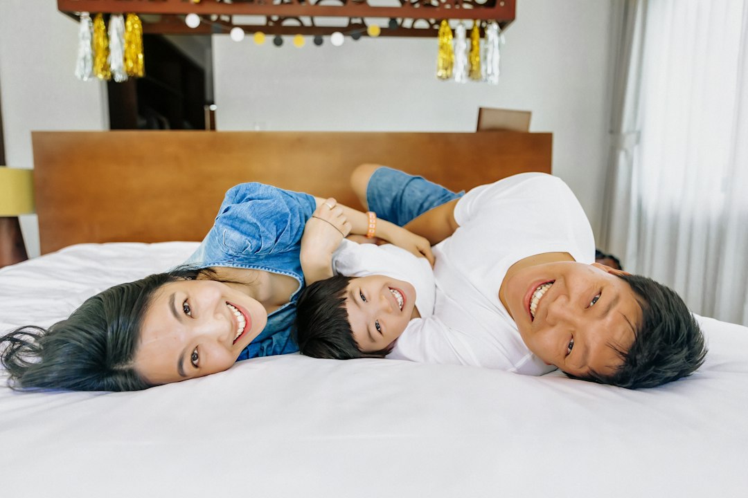 A happy family lying on a bed together