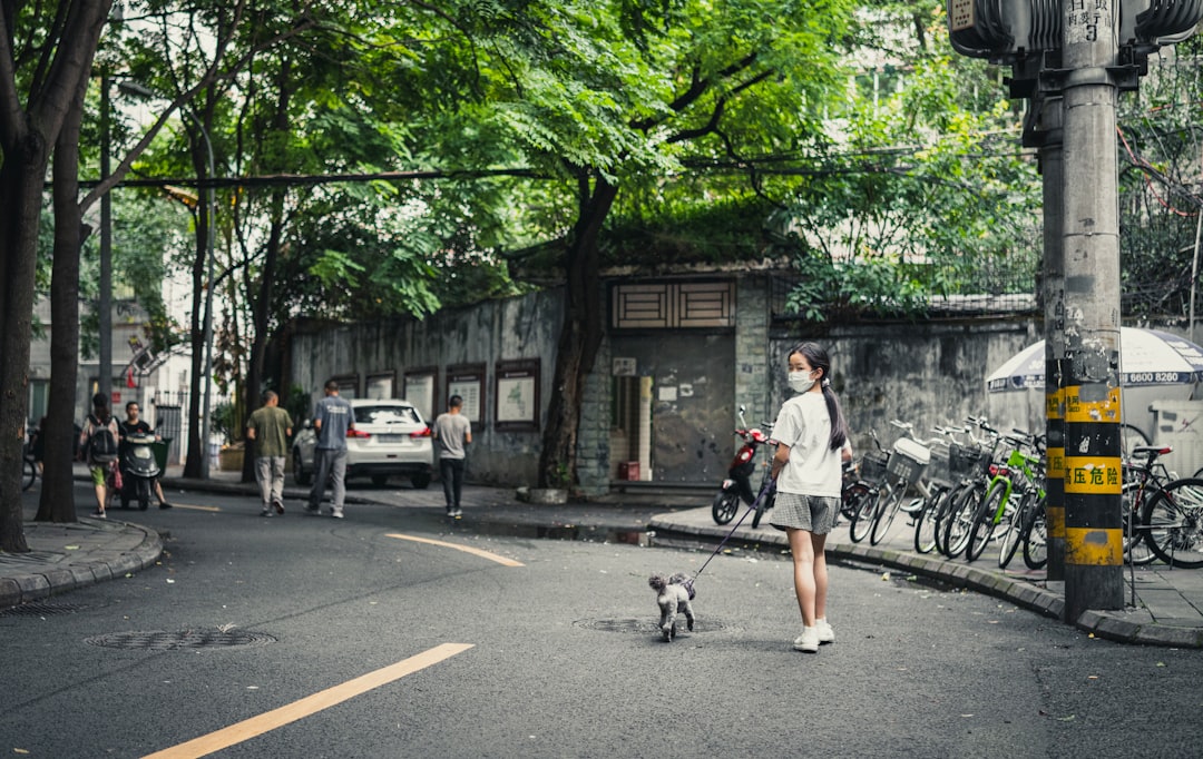 man in white shirt riding bicycle on road during daytime
