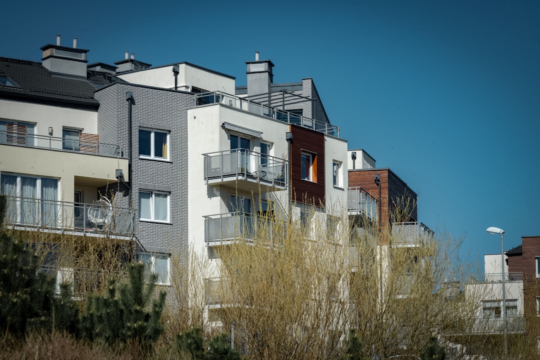 Modern apartment buildings with balconies under blue sky