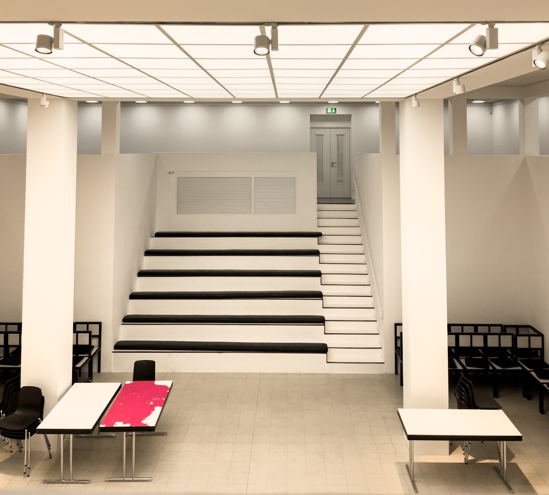 Modern white hall with tiered seating and tables