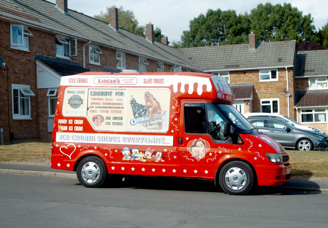 A red ice cream truck parked on a residential street