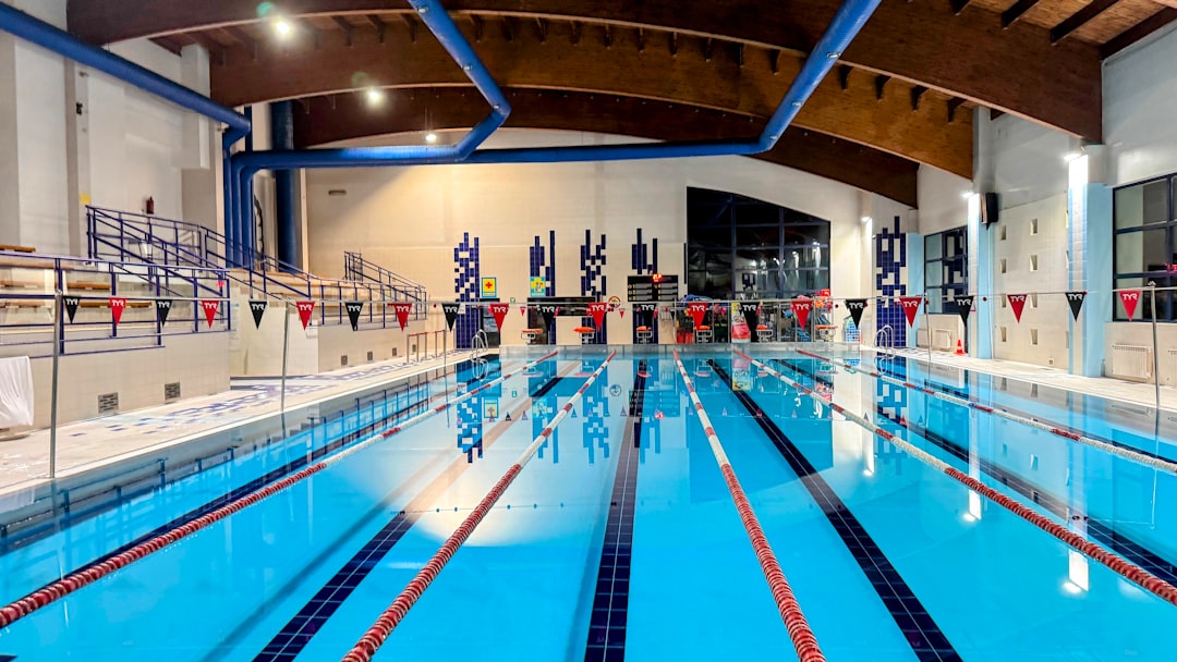 An indoor swimming pool with blue water