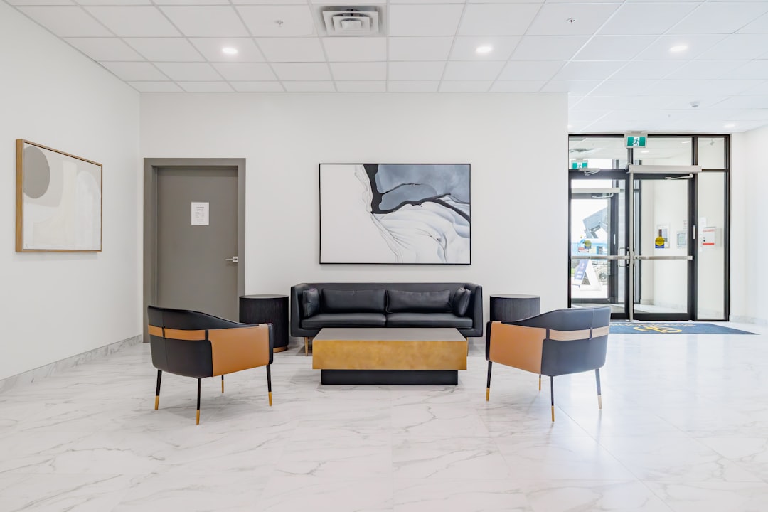 Modern lobby with black leather sofa and chairs.