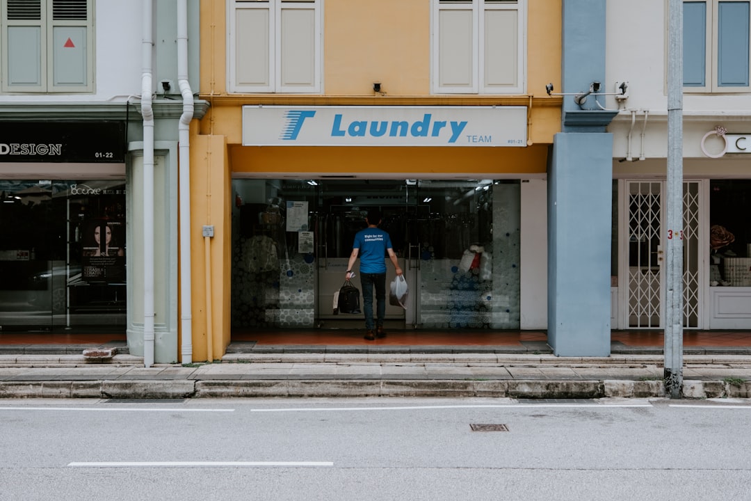 a store front with a man walking in the doorway