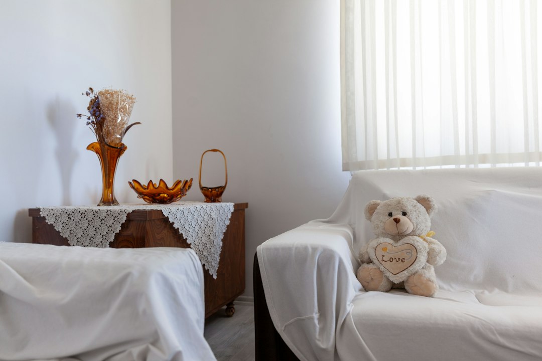 Teddy bear with heart on a white couch