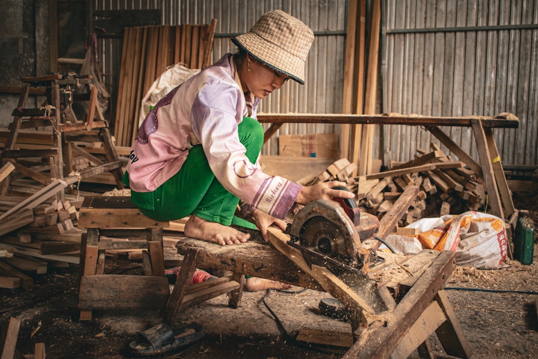 Woman using a saw in a workshop