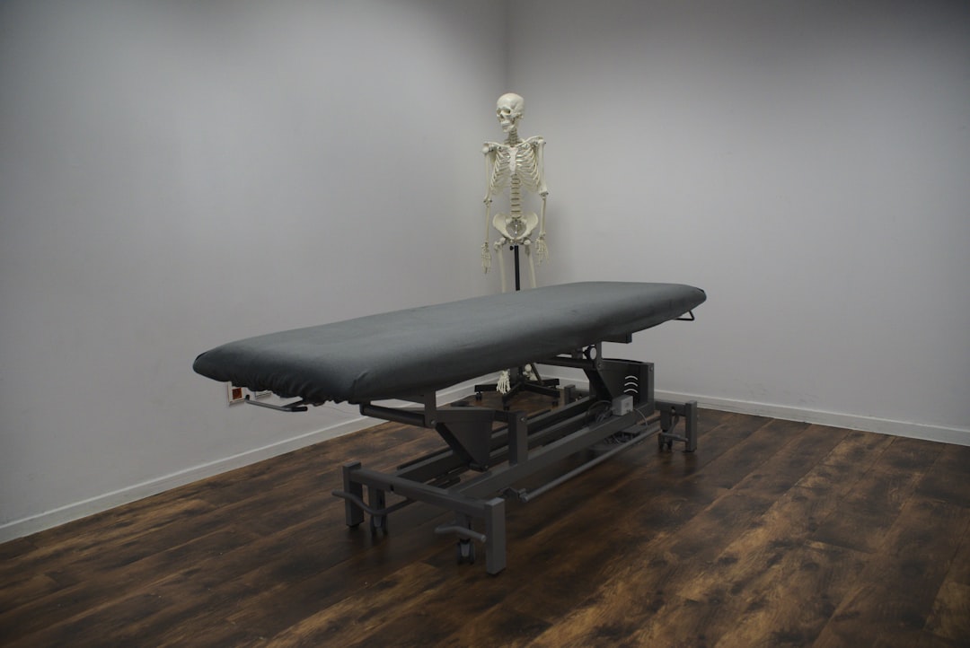 black bed frame on brown wooden parquet floor