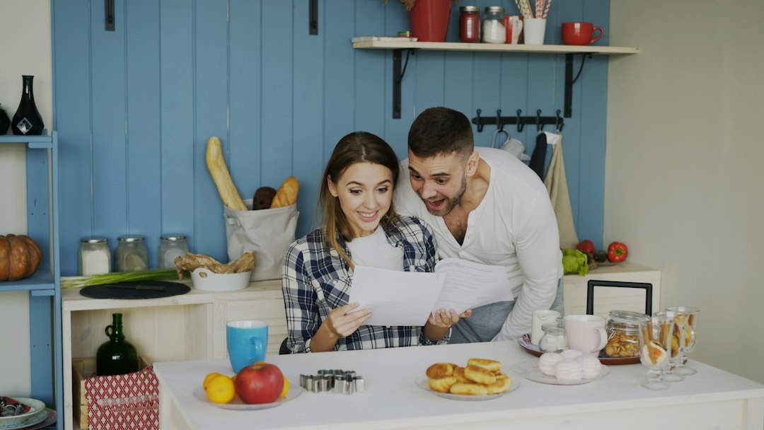 Couple looking at papers in a bright kitchen