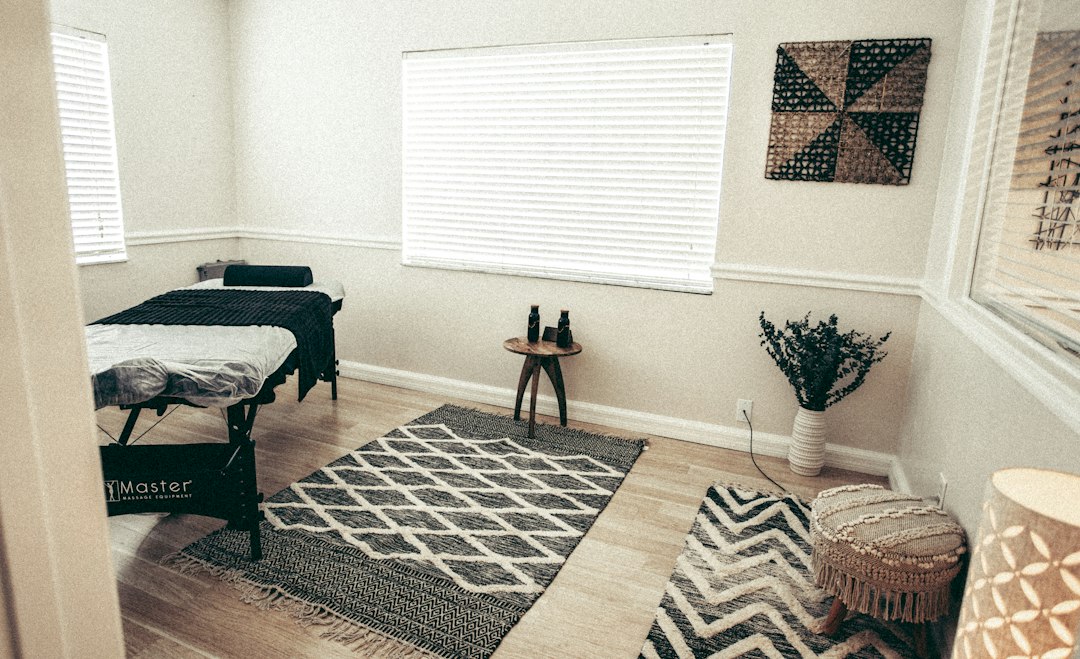 brown wooden table on brown and white area rug