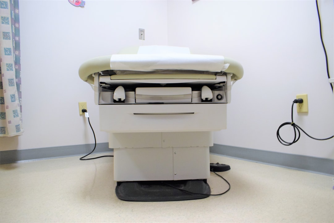a hospital room with a bed and a charger