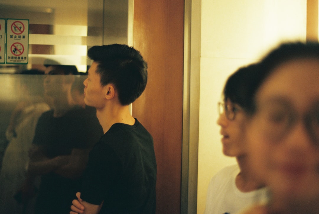 Three young men in a dimly lit space