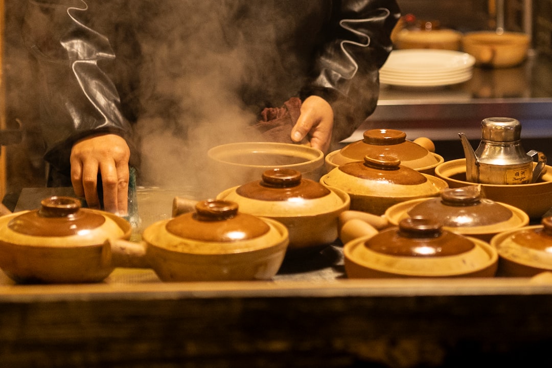 A man cooking food on top of a wooden table