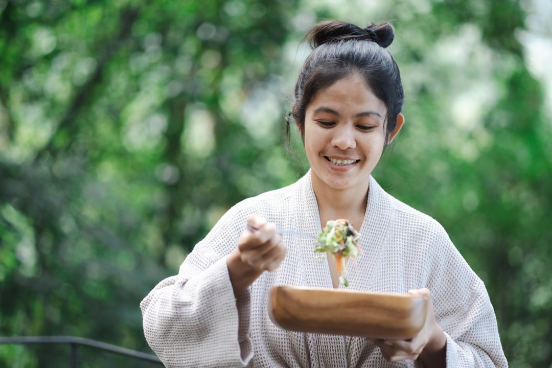 a woman in a kimono holding a plate of food