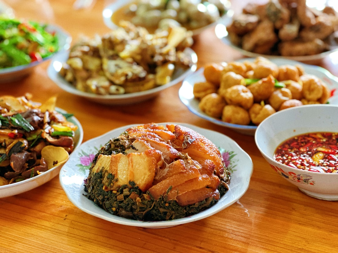a wooden table topped with plates of food