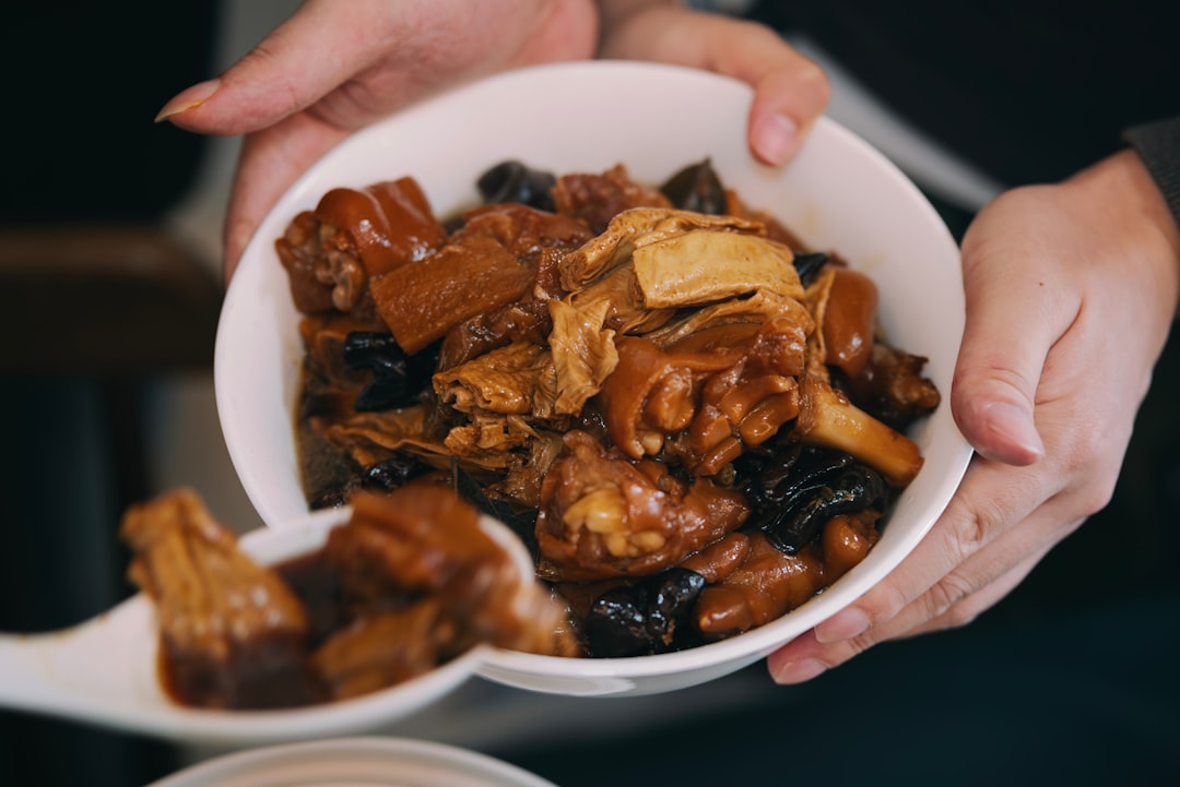a person holding a bowl of food in their hands