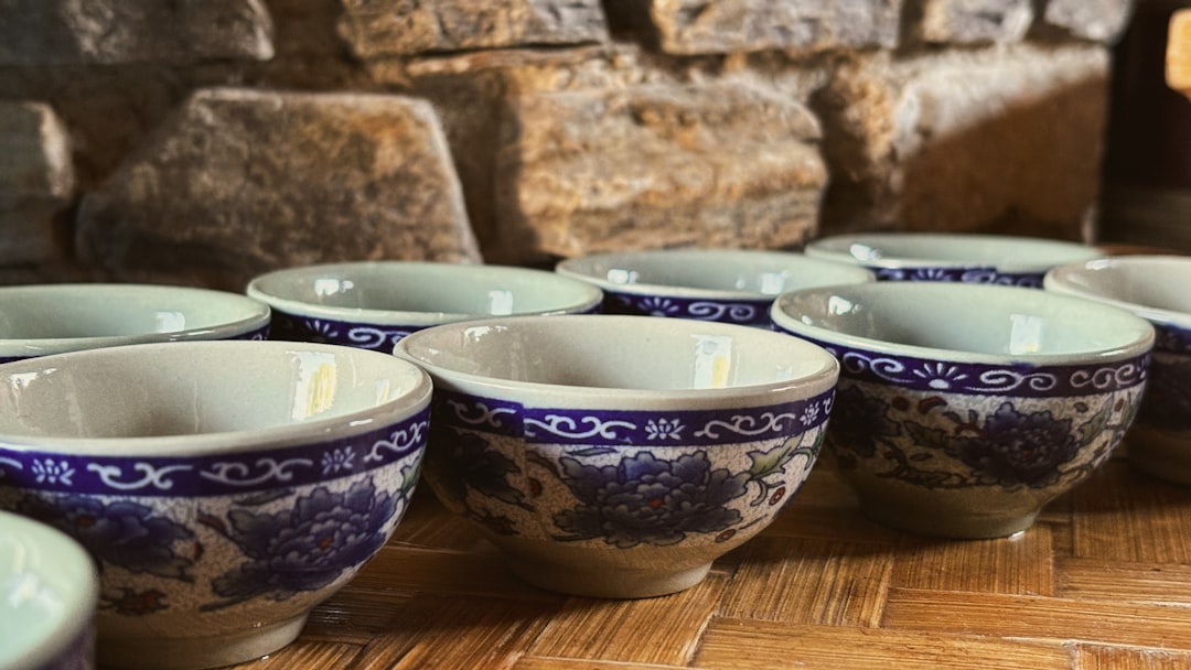 Several small ceramic tea cups with blue floral patterns.