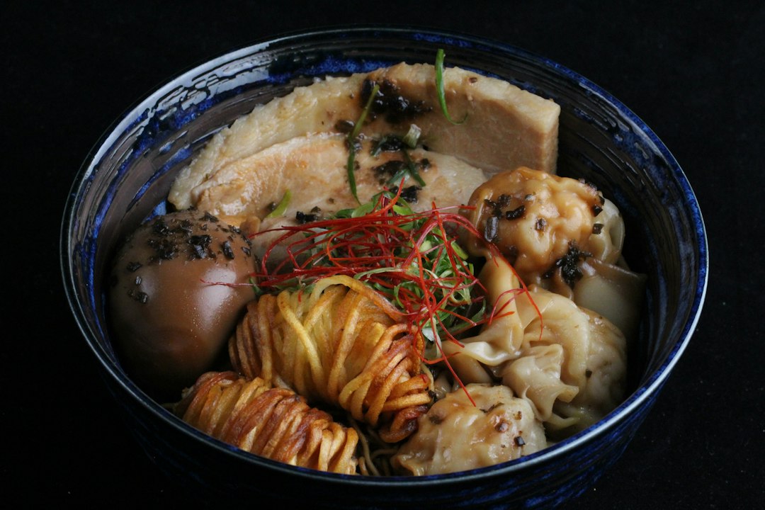 a blue bowl filled with different types of food