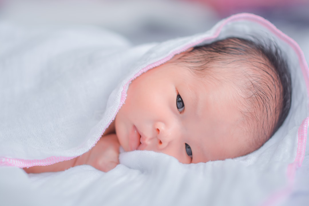 a close up of a baby under a blanket