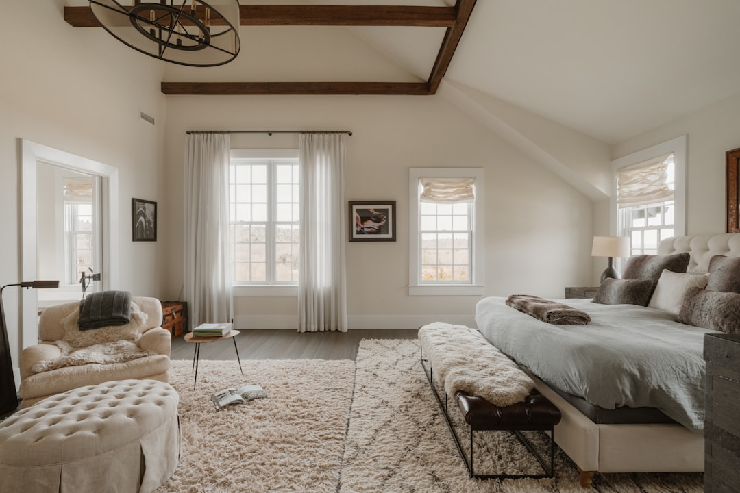 Spacious bedroom with large bed and cozy seating area.