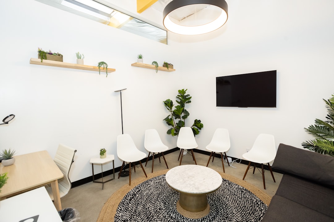 Modern waiting room with white chairs and plants