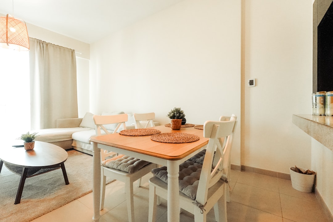 Dining table and chairs in a bright room.