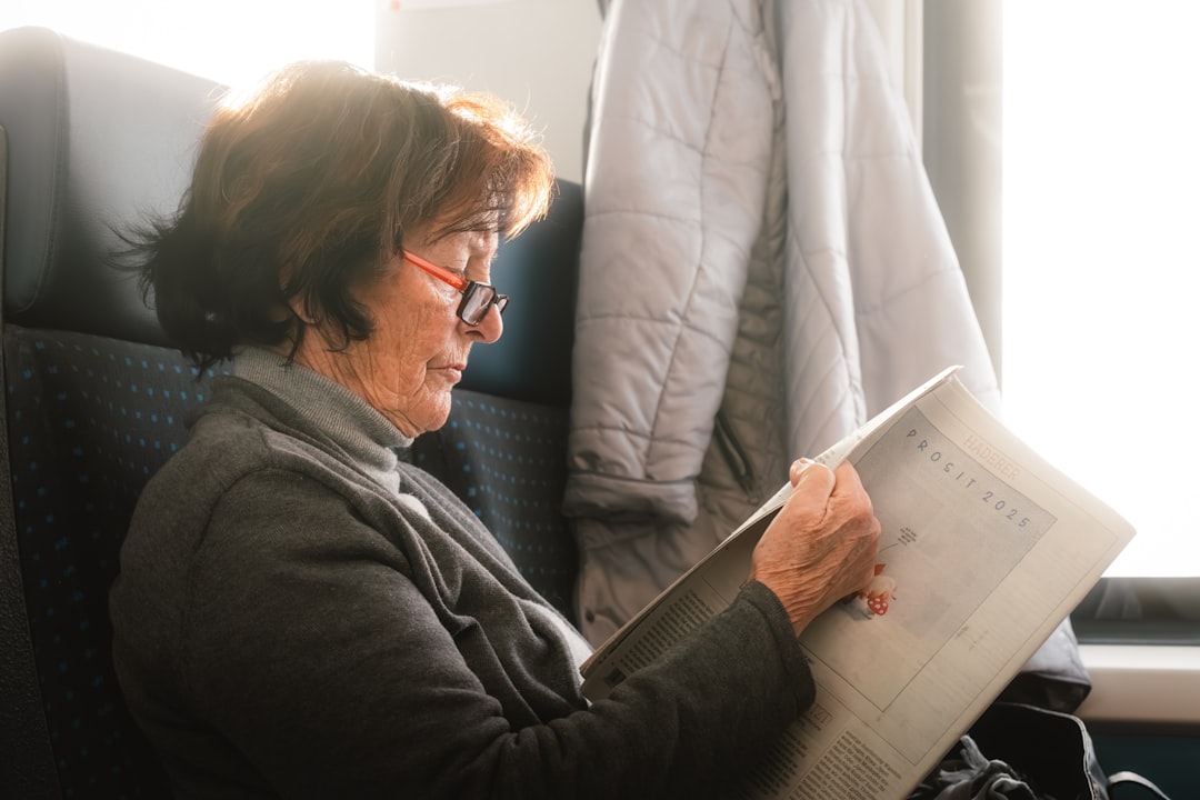 A woman sitting in a chair reading a book