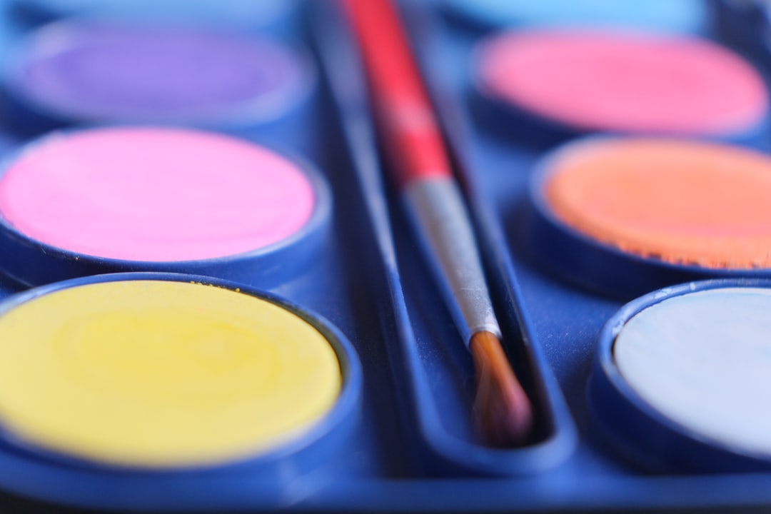 a close up of a palette of paint and a brush