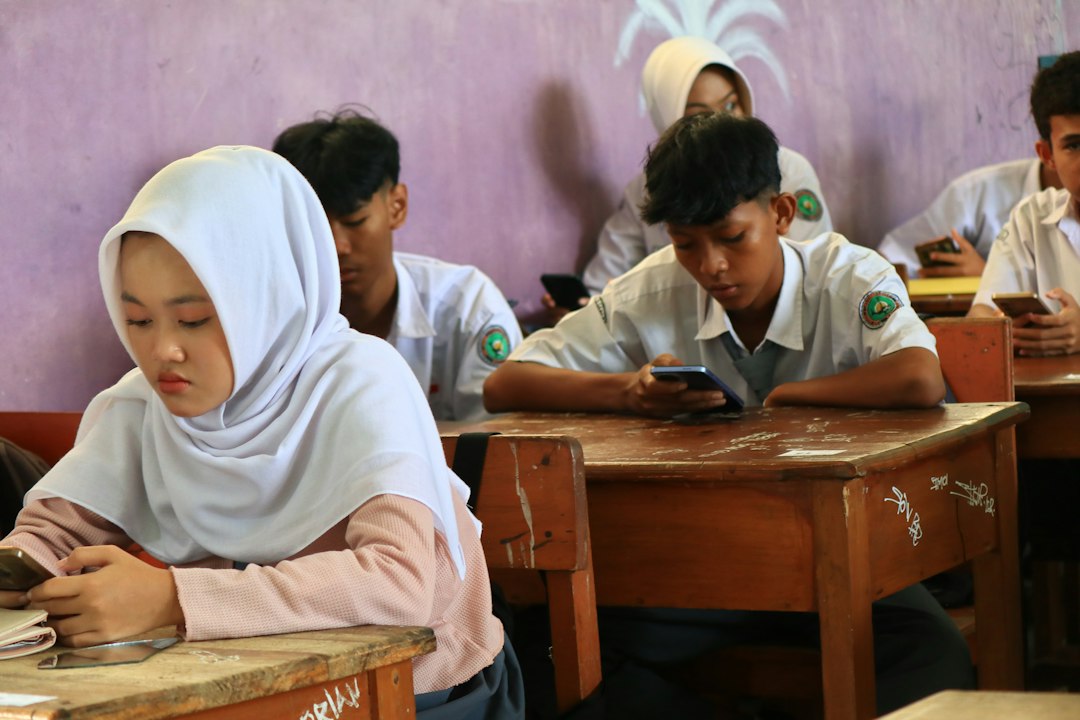 Students in a classroom using mobile phones