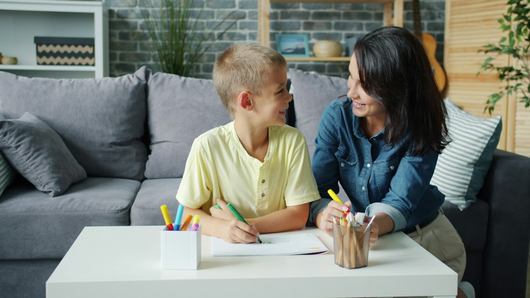 Mother and son drawing at a table together