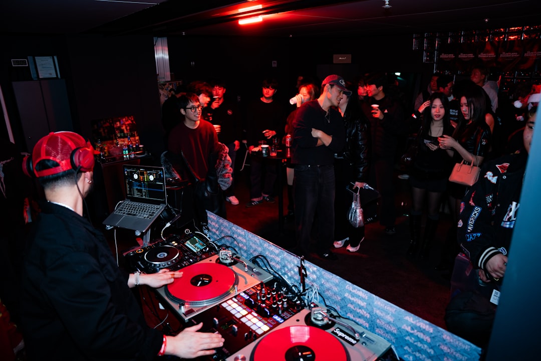 Dj playing music for a crowd at a club
