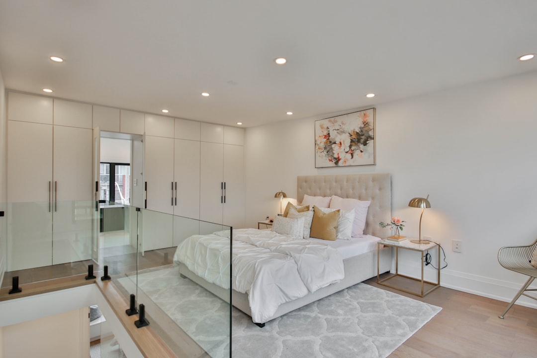 a bedroom with a large bed and a glass wall