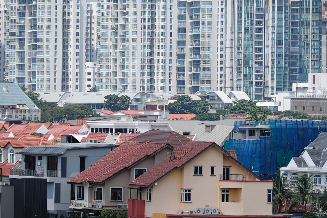 a group of buildings with trees in the front