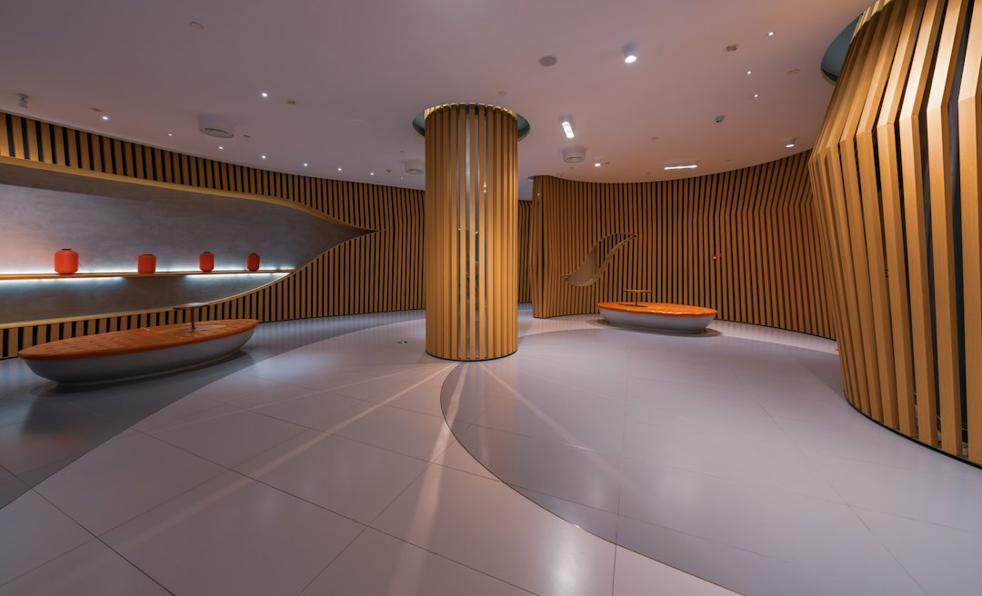 Modern interior with curved wooden panels and red displays
