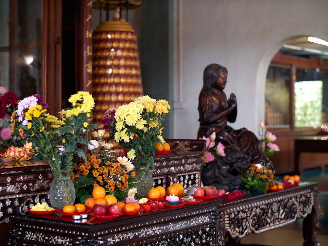 An ornate altar is set with flowers and fruit.