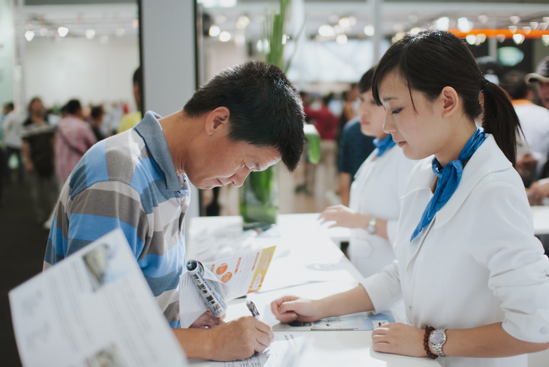 Man signs document at a service counter