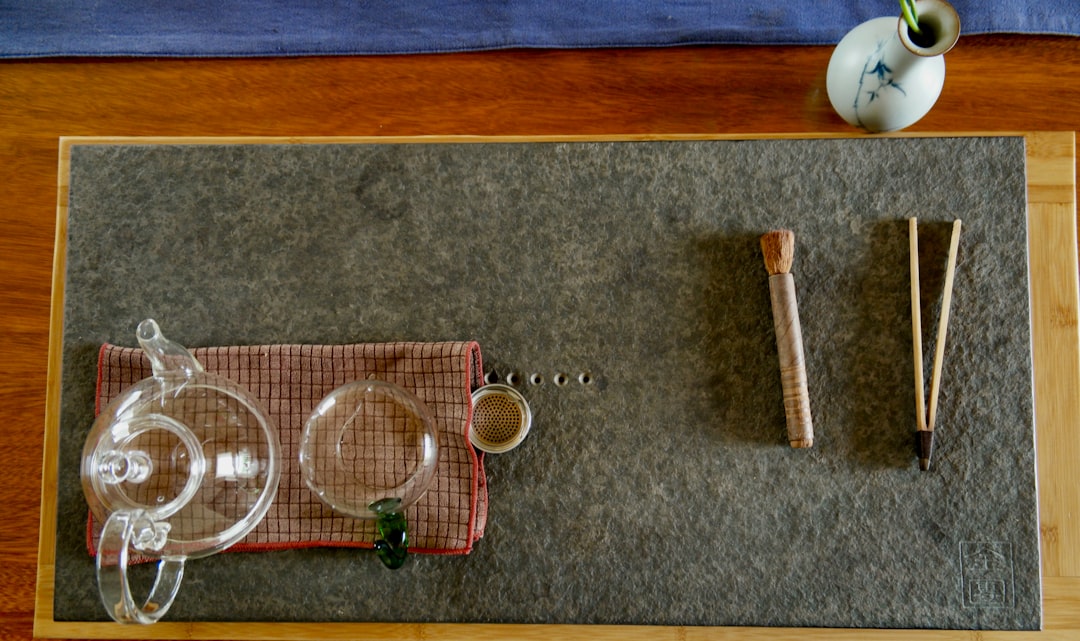 aerial photography of glass teapot on table with cloth