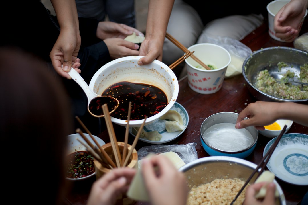 people eating using chopsticks