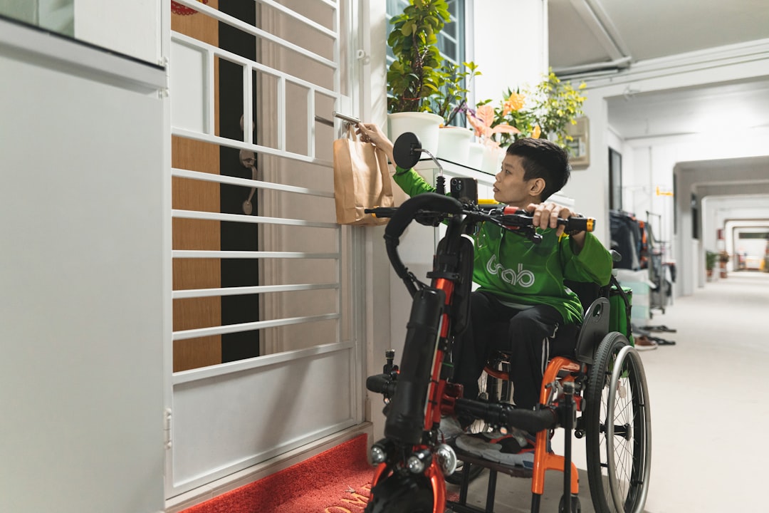a man in a green shirt in a wheel chair