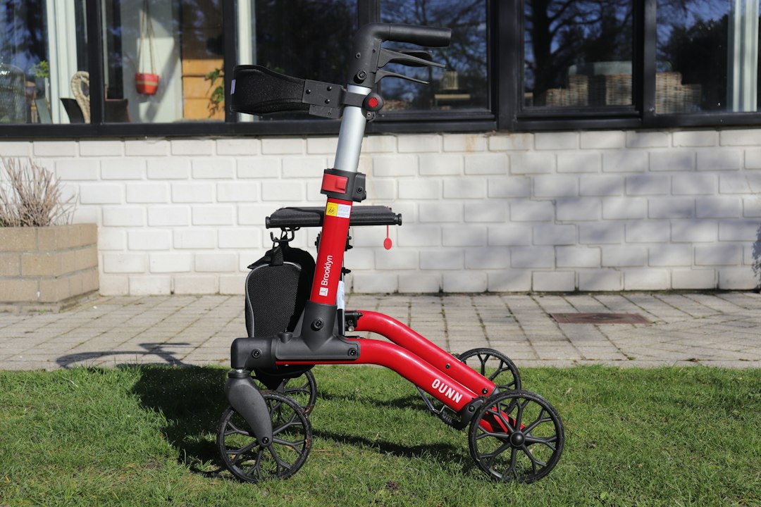 Red walker with four wheels on grass