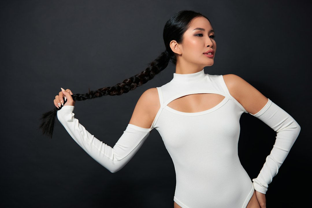 woman in white long sleeve shirt holding black microphone
