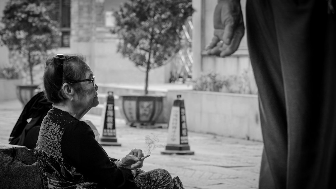woman in eyeglasses sitting on chair