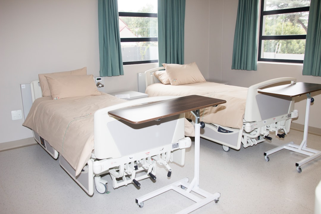 white hospital bed near window