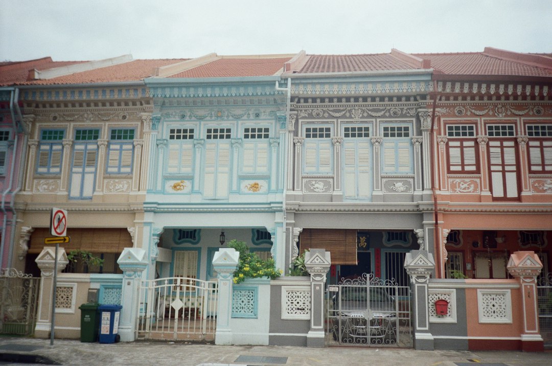 Row of colorful traditional shophouses with ornate facades