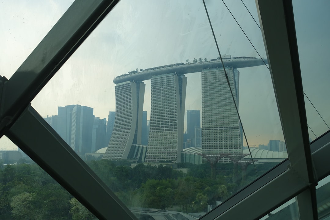 Marina bay sands hotel seen through a modern glass structure