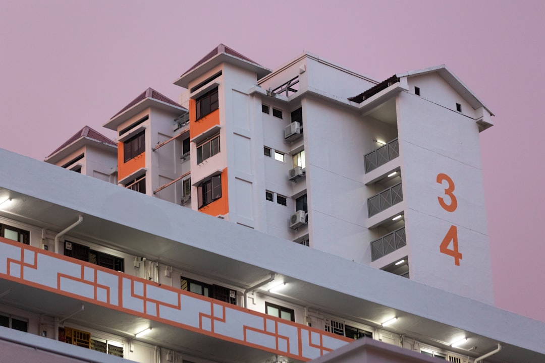 A multi-story building in a beautiful purple sky.